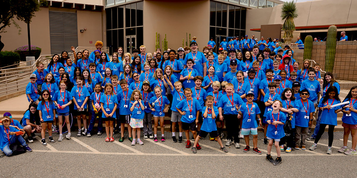Approximately 140 kids pose for an image following Kids Day 2025