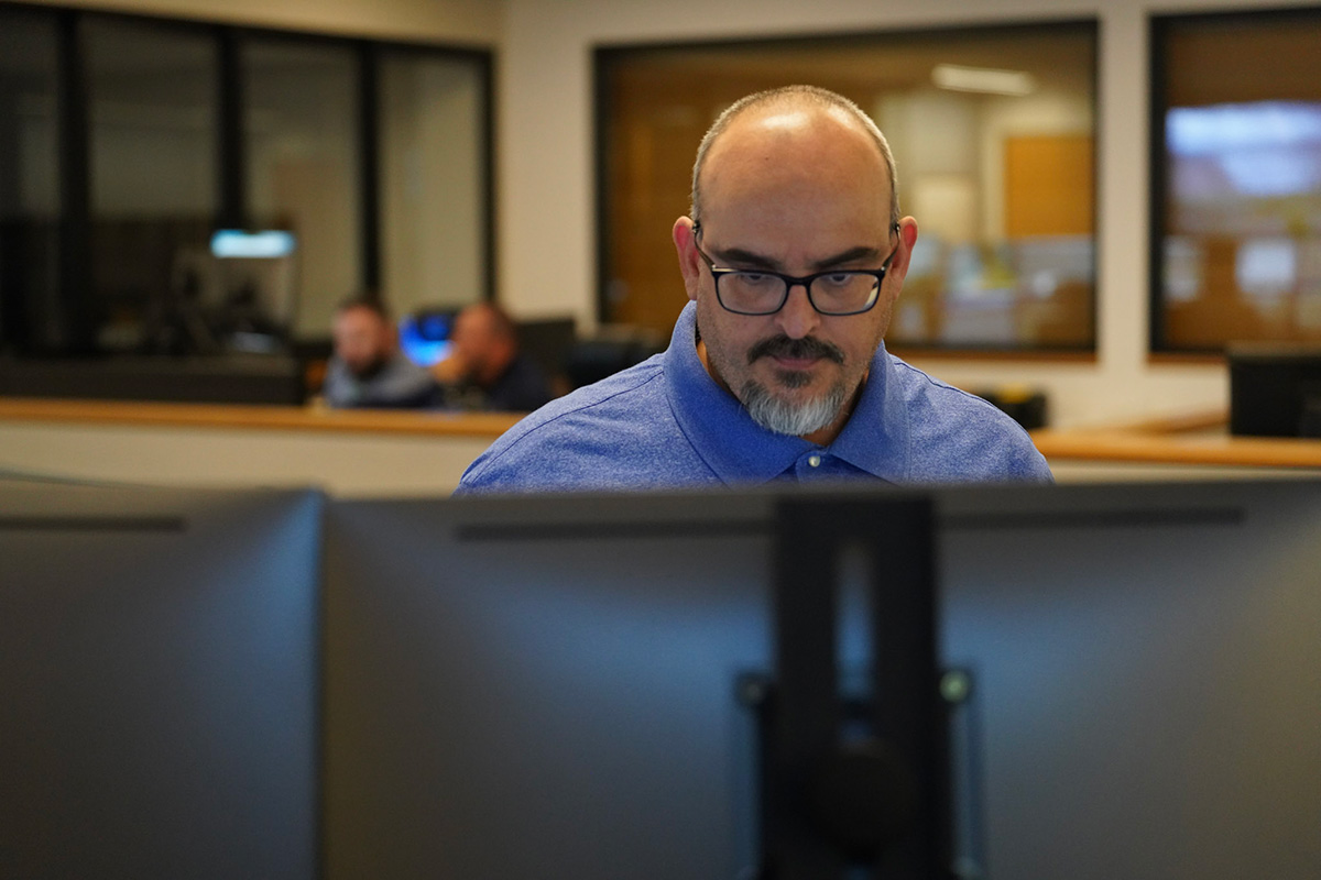 CAP Water Control dispatcher Miguel Ayala adjusts water deliveries the morning after a night of monsoon storms.
