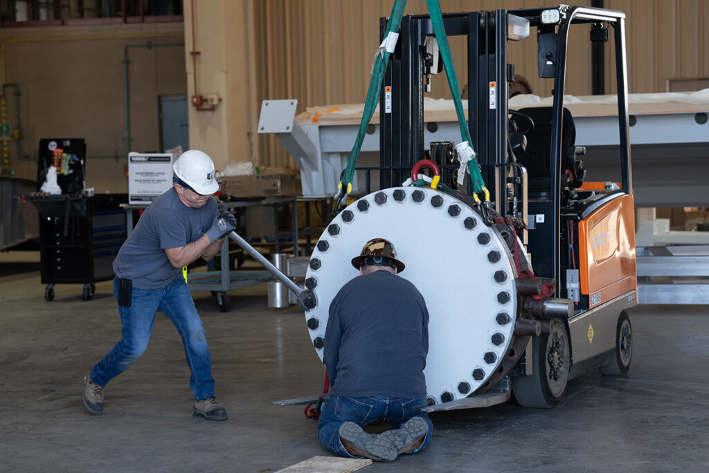 Millwright mechanics test a discharge valve for leaks.