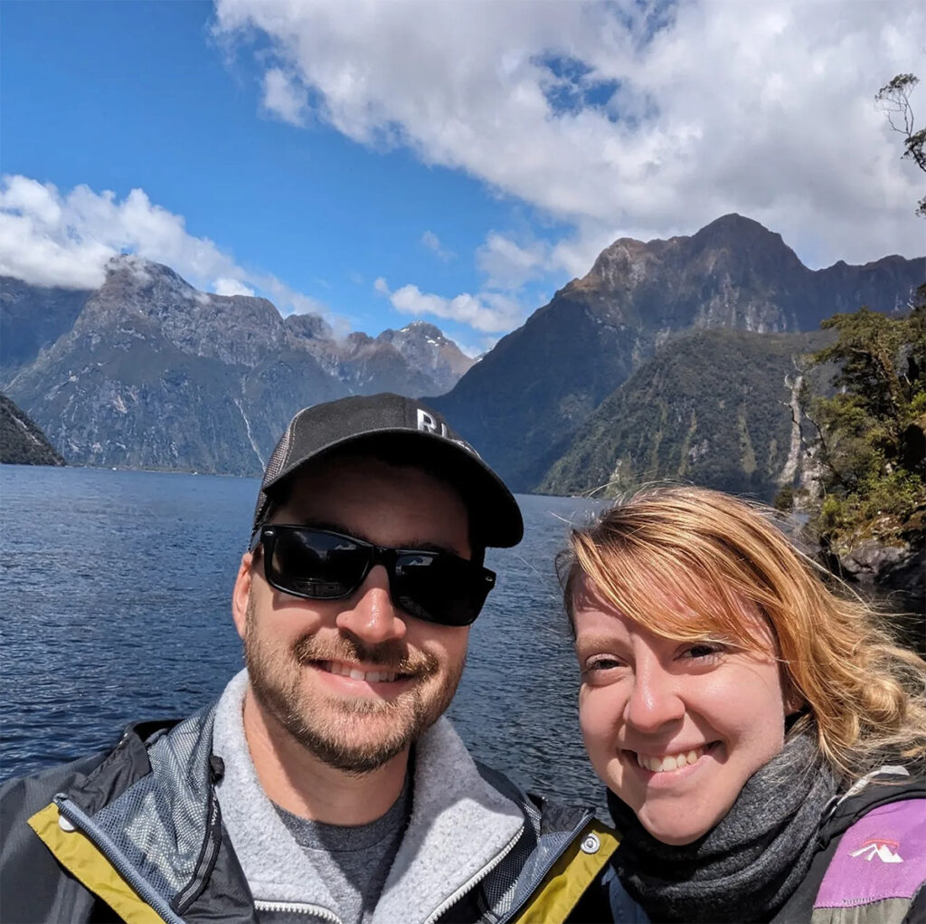 Chris Kloskin selfie with wife in front of mountain and water view