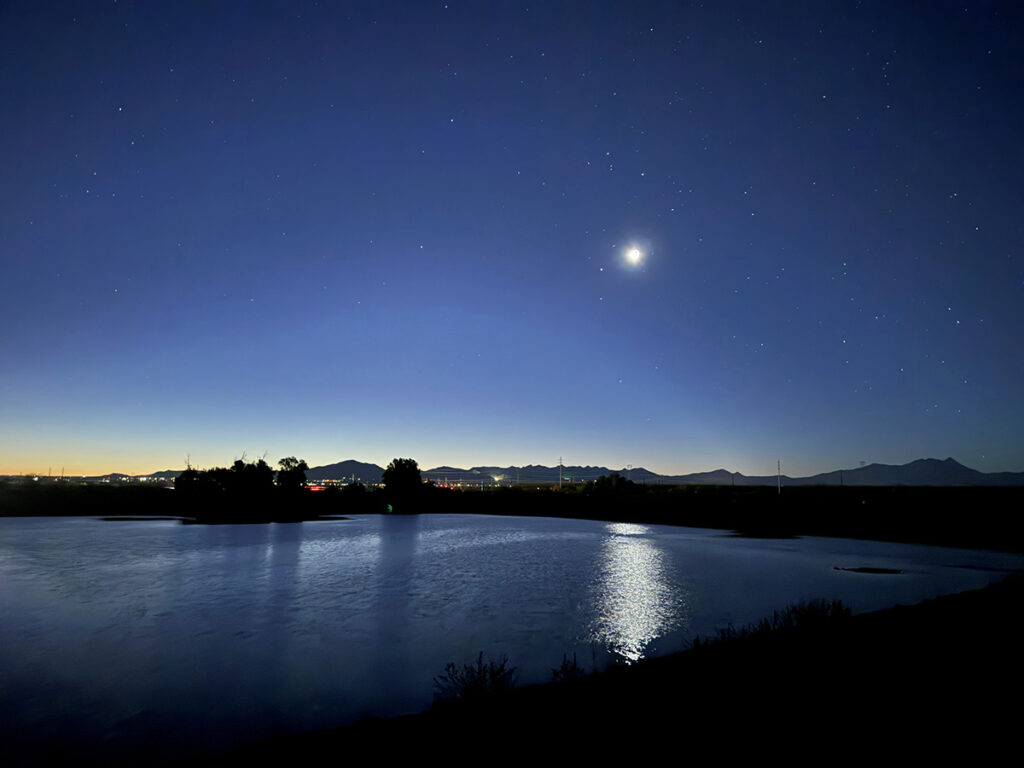 Moon and stars over water