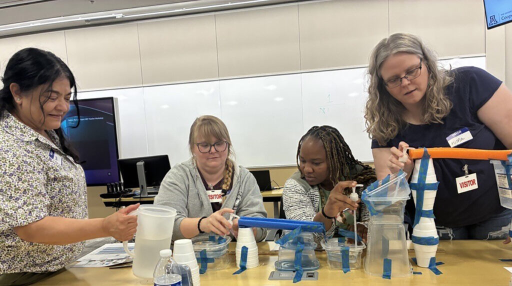 Teachers and students use pool noodles, duct tape, Styrofoam cups and plastic containers to engineer a water delivery system