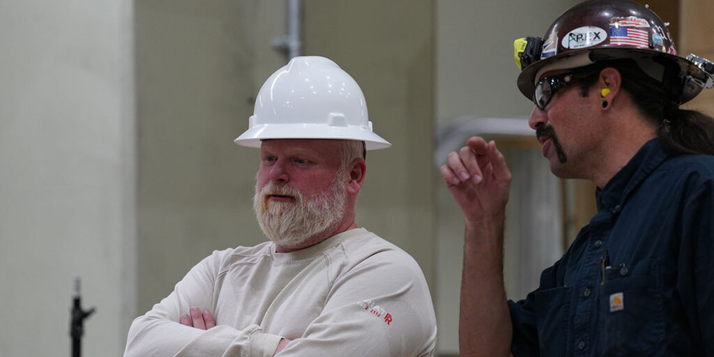 CAP employee Al Hawes talking with fellow employee