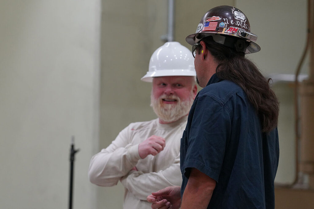 CAP employee Al Hawes talking with fellow employee